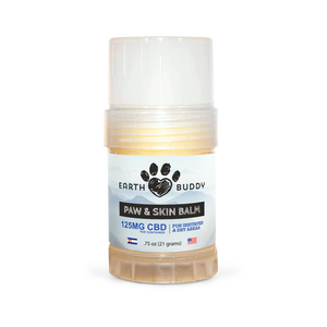 A tube of Earth Buddy hemp 125 mg Paw & Skin Balm for dogs on a wooden table. Perfect for dry skin & noses.
