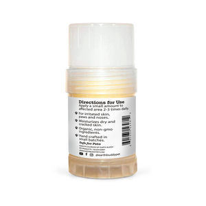 A tube of Earth Buddy hemp 125 mg Paw & Skin Balm for dogs on a wooden table. Perfect for dry skin & noses.
