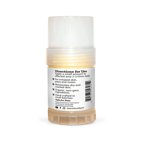 A tube of Earth Buddy hemp 125 mg Paw & Skin Balm for dogs on a wooden table. Perfect for dry skin & noses.
